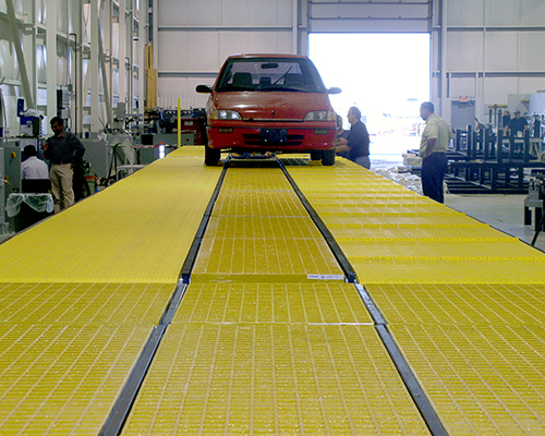 Yellow Molded Fiberglass Trench Cover being tested for Eclipse Car Wash